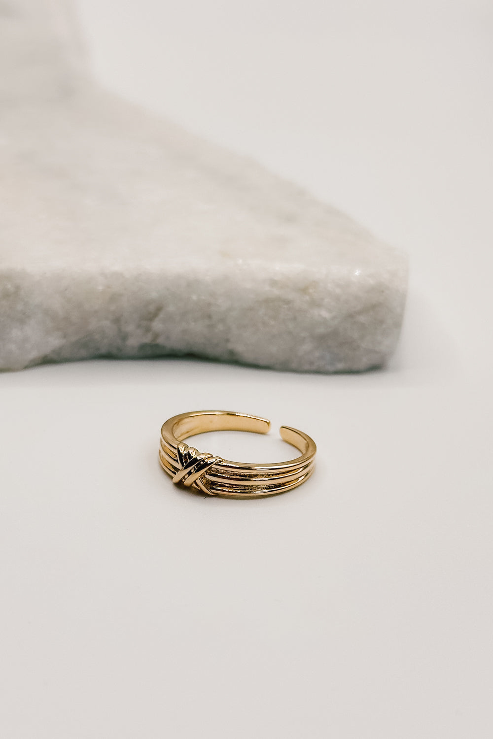 front view of the Noelle Gold Dipped Ribbed Twist Ring which features gold dipped ring with twist details