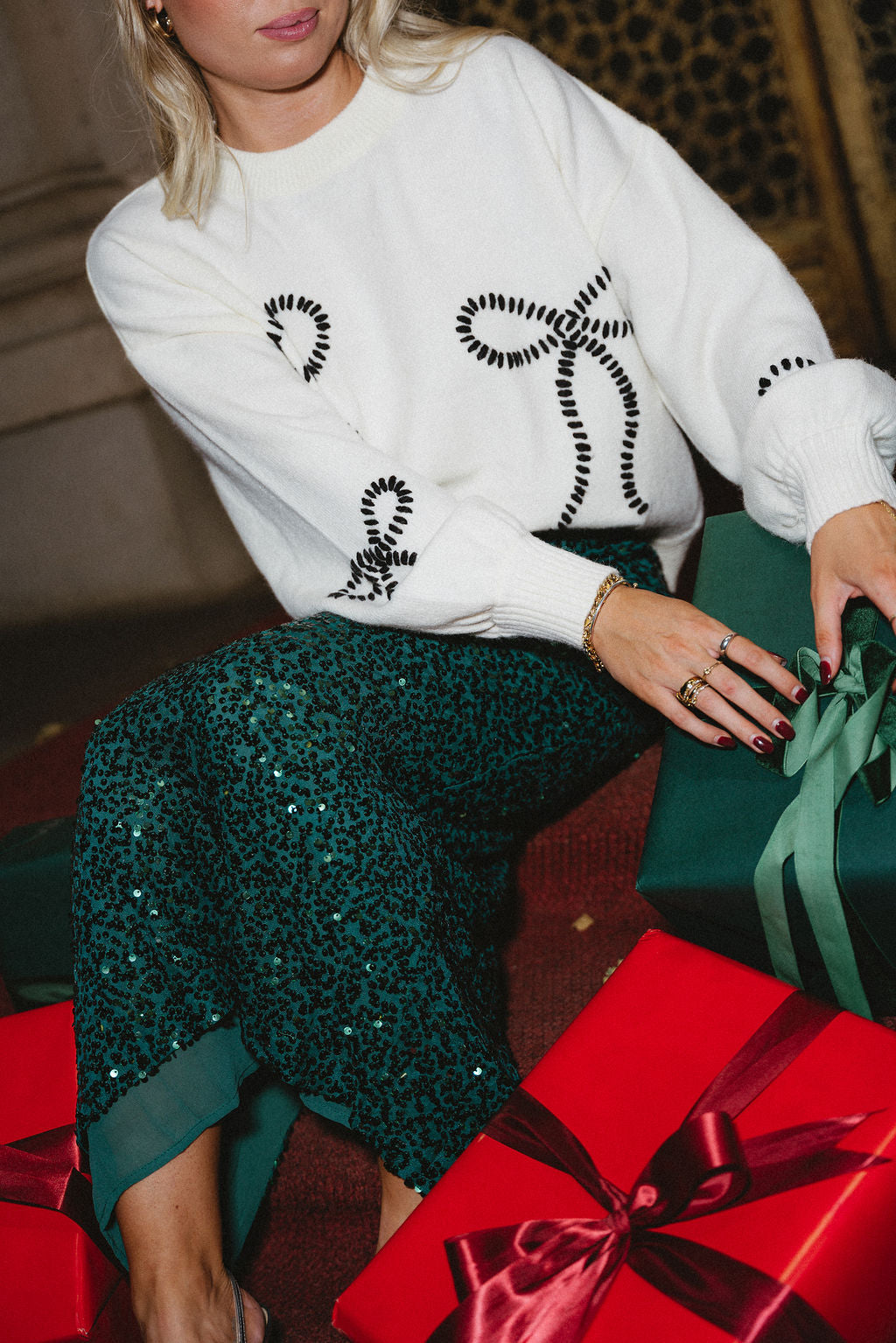 Grace Cream & Black Stitch Bows Sweater- front sitting view - holiday background