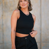 Front view of female model wearing the Andrea Black Ribbed Sleeveless Tank which features Black Ribbed Fabric, Cropped Waist, Round Neckline and Sleeveless