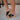Right side view of female model wearing the B.O.C. Born Concept Sunny Wedge Sandal in Black which features Black Faux Leather Upper, Slip-On Style and Criss-Cross Strap & Toe Wrap Detail