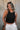 Front view of female model wearing the Julie Ribbed Sleeveless Tank in Black which features Ribbed Lightweight Fabric, Round Neckline and Sleeveless.