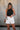 Front view of female model wearing the Julie Ribbed Sleeveless Tank in Black which features Ribbed Lightweight Fabric, Round Neckline and Sleeveless.