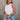 Front view of female model wearing the Julie Ribbed Sleeveless Tank in White which features Ribbed Lightweight Fabric, Round Neckline and Sleeveless.