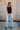 Full body view of female model wearing the Brielle Black Sleeveless Tank which features Black Lightweight Fabric, Round Neckline and Sleeveless 