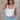 Front view of female model wearing the Leigh Square Neckline Sleeveless Tank which features Ribbed Lightweight Fabric, Square Neckline and Sleeveless. the tank is available in white and black.