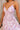 Close-up upper body front view of female model wearing the Bridget Lavender Watercolor Midi Dress that has a lavender watercolor floral pattern, a corset top, thin straps, and midi length