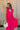 Front view of female model wearing the Kristina Pink Smocked Sleeveless Midi Dress that has hot pink fabric, side slit pockets, midi length, smocked upper, a scoop neckline, and ruffled straps.