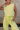 Front view of female model wearing the Alexis Green Sleeveless Jogger Jumpsuit which features Light Green Knit Fabric, Jogger Pant Legs, Side Pockets, Drawstring Tie Waistband and overlap Open Back with Button Closure