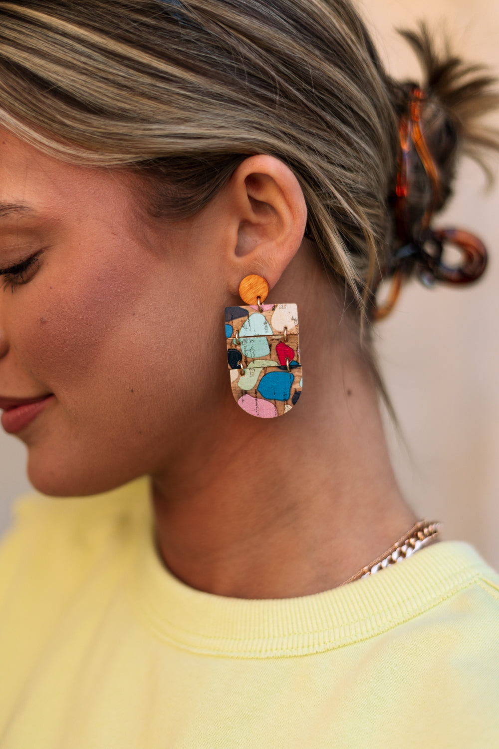 Side view of the Wrenly Cork Multi Dangle Earring which features cork dangle earrings with multi color spots design