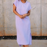 Full body view of female model wearing the Luna Lavender Ribbed Midi Dress which features Lavender Ribbed Fabric, Midi Length, Slit Side Details, Round Neckline and Short Sleeves