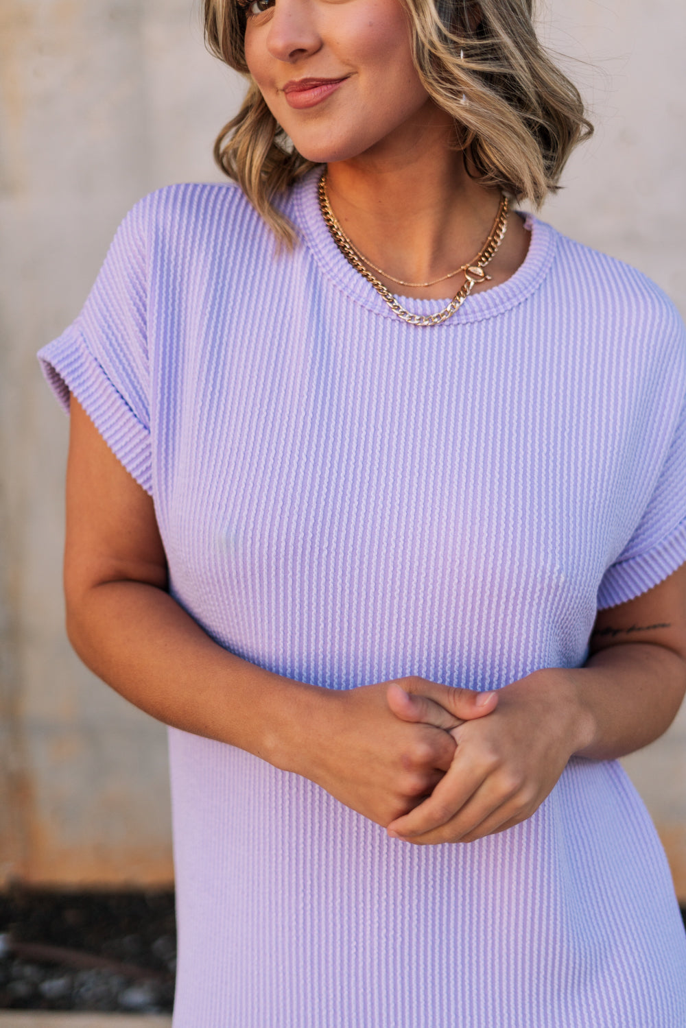 Front view of female model wearing the Luna Lavender Ribbed Midi Dress which features Lavender Ribbed Fabric, Midi Length, Slit Side Details, Round Neckline and Short Sleeves
