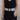 Front view of female model wearing the Taryn Black & Natural Woven Belt which features Natural Woven Fabric, Black and Grey Wave Thread Design and Black Acrylic Adjustable Buckle