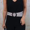 Front view of female model wearing the Taryn Black & Natural Woven Belt which features Natural Woven Fabric, Black and Grey Wave Thread Design and Black Acrylic Adjustable Buckle