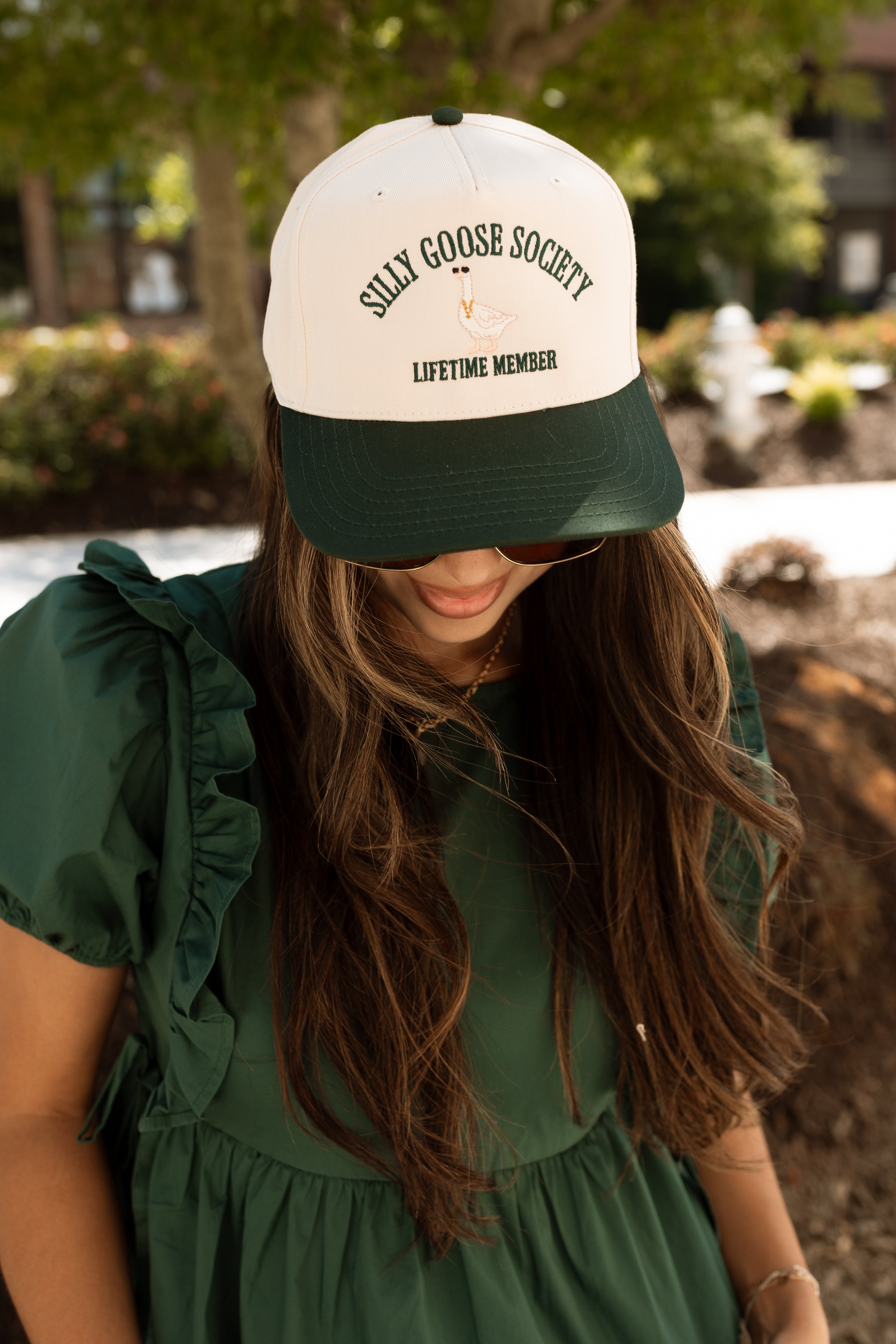 Front view of female model wearing the Silly Goose Society Trucker Hat 