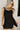Front view of female model wearing the Livia Black Denim Dress that has black denim, tie straps, and back zipper.