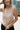 Front view of female model wearing the Cecilia Taupe Padded Shoulder Tank that has taupe knit fabric, a round neck, and padded sleeveless shoulders.