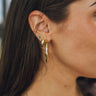 Close up of model wearing the Hazel Gold Hoops. These are simple gold hoop earrings. 