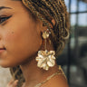 Close up of model wearing the Gianna Gold Flower Dangle Earrings. These are gold 3d flower dangle earrings.