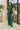 Full body view of model wearing the Naya Forest Green Pants. These are green pants with a wide leg look.