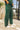 Close up of model wearing the Naya Forest Green Pants. These are green pants with a wide leg look.