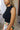 Close up of model wearing the Emerie Black Tank. This is a black sleeveless tank with a high neckline.