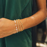 Close up of model wearing the Stella Gold and Pearl Beaded Bracelet. This is a gold and pearl beaded bracelet.