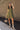 Full body view of model wearing the Holly Olive Mini Dress. This is a green mini dress with a zipper up the front and ruffled bottom, V neckline, sleeveless.
