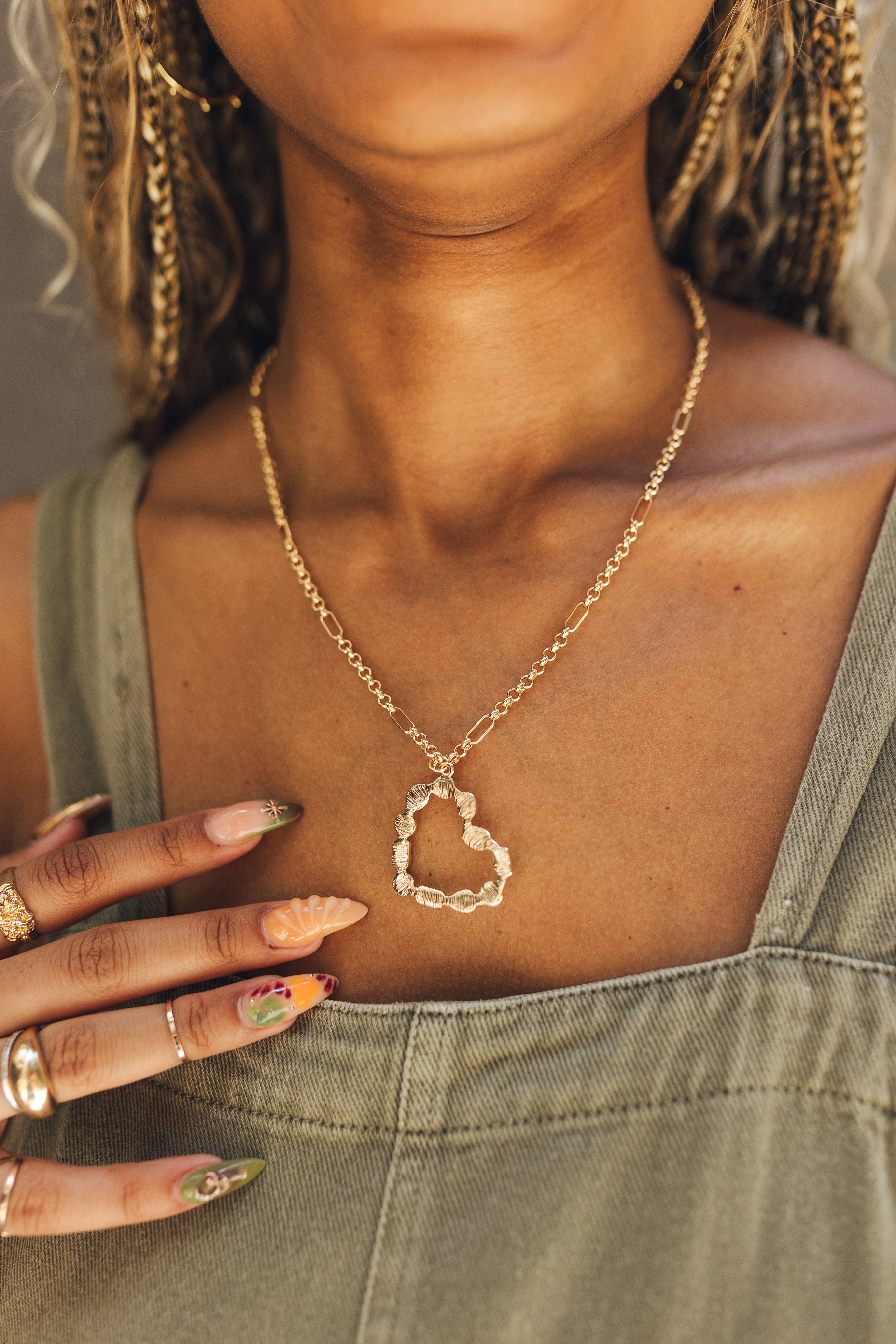 Close up of model wearing the Rylee Gold Heart Necklace. This is a gold necklace with bead heart.