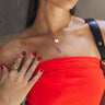 Close up of model wearing Aria Cherry Gold Necklace. This is a layered gold necklace with cherries and red beads.