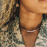 Close up of model wearing the Malia Gold and Pearl Necklace. This is a beaded gold and pearl necklace.