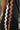 Close up of trim on the Lillian Black Midi Dress. This is a black sleeveless midi dress with rust and cream wavy trim on sides, slit on bottom.