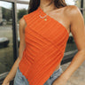 Close up of model wearing the Kiana One Shoulder Top. This is a knit top, one shoulder and open side. Options of either rust or taupe. 