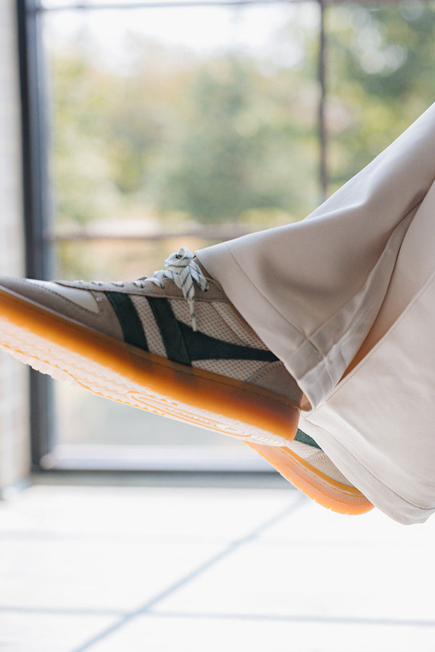 Gola Hawk Trainer Off White & Evergreen Sneaker - close up side view on model