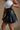 Nylah Black Faux Leather Pleated Skirt- close up side view