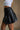 Nylah Black Faux Leather Pleated Skirt- frontal side view