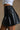 Nylah Black Faux Leather Pleated Skirt- close up view