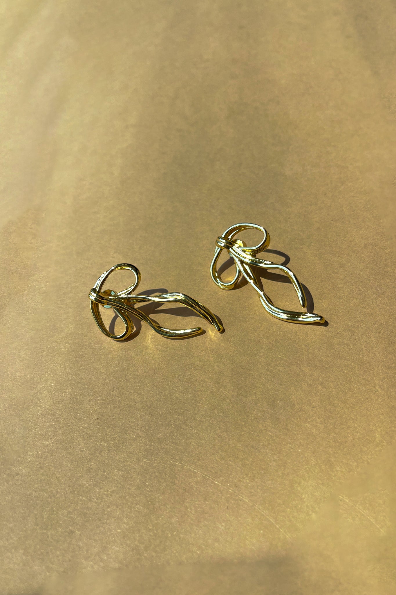 Natalia Gold Hammered Bow Earring- close up view