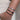 Wrist in pocket with stack of silver bracelets