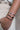 Wrist in pocket with stack of silver bracelets