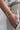 Stack of gold bangles on wrist 