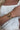 wrist with stack of gold bracelets