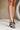 Front view of model's legs; model is wearing the Yola Black Knot Strap Sandals.