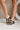 Side view of model's legs; model is wearing the DV by Dolce Vita Yola Black Knot Strap Sandals