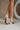 image shows back view of model's legs; model is wearing the Adina Metallic Heels in Silver