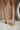 image shows front view of model's legs; model is wearing the Adina Metallic Heels in Gold 