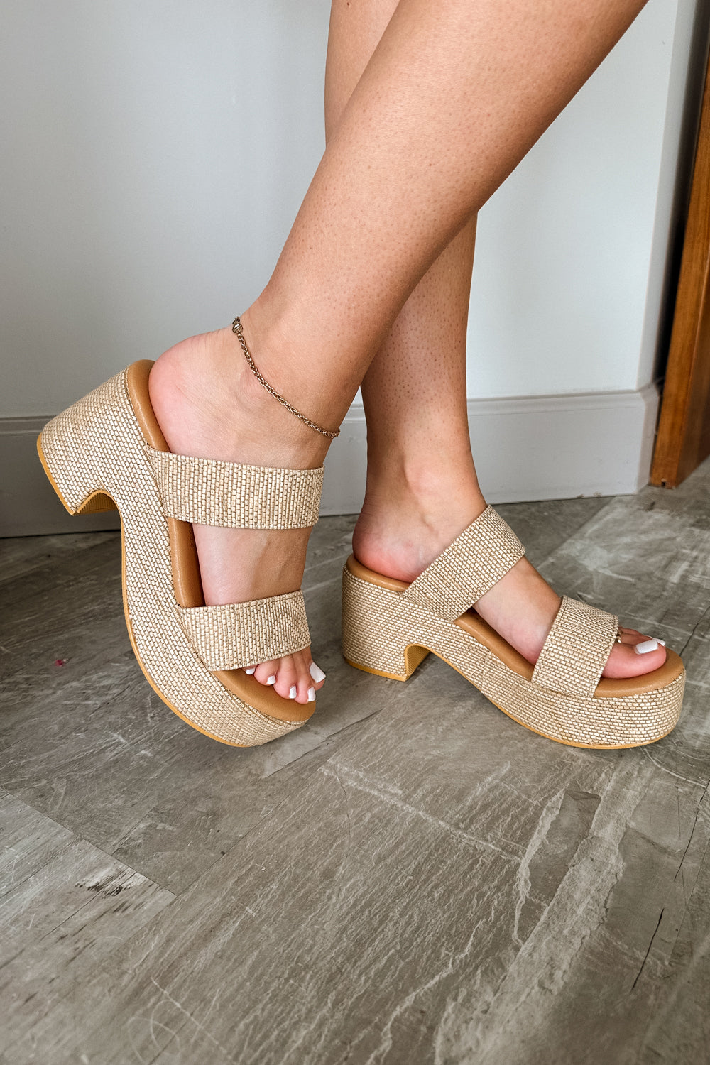 Side view of female model wearing the Ocean Avenue Platform Sandal in Natural which features Natural Tan Fabric, Chunky Platform, Block Heel, Slide-On Style and Two Strap Design