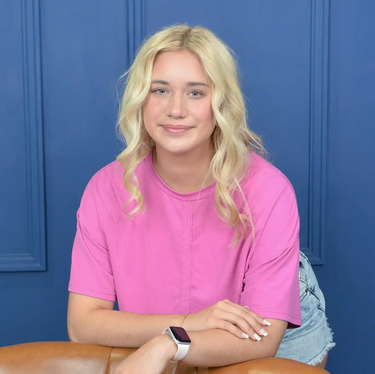 image of blonde girl in a pink shirt