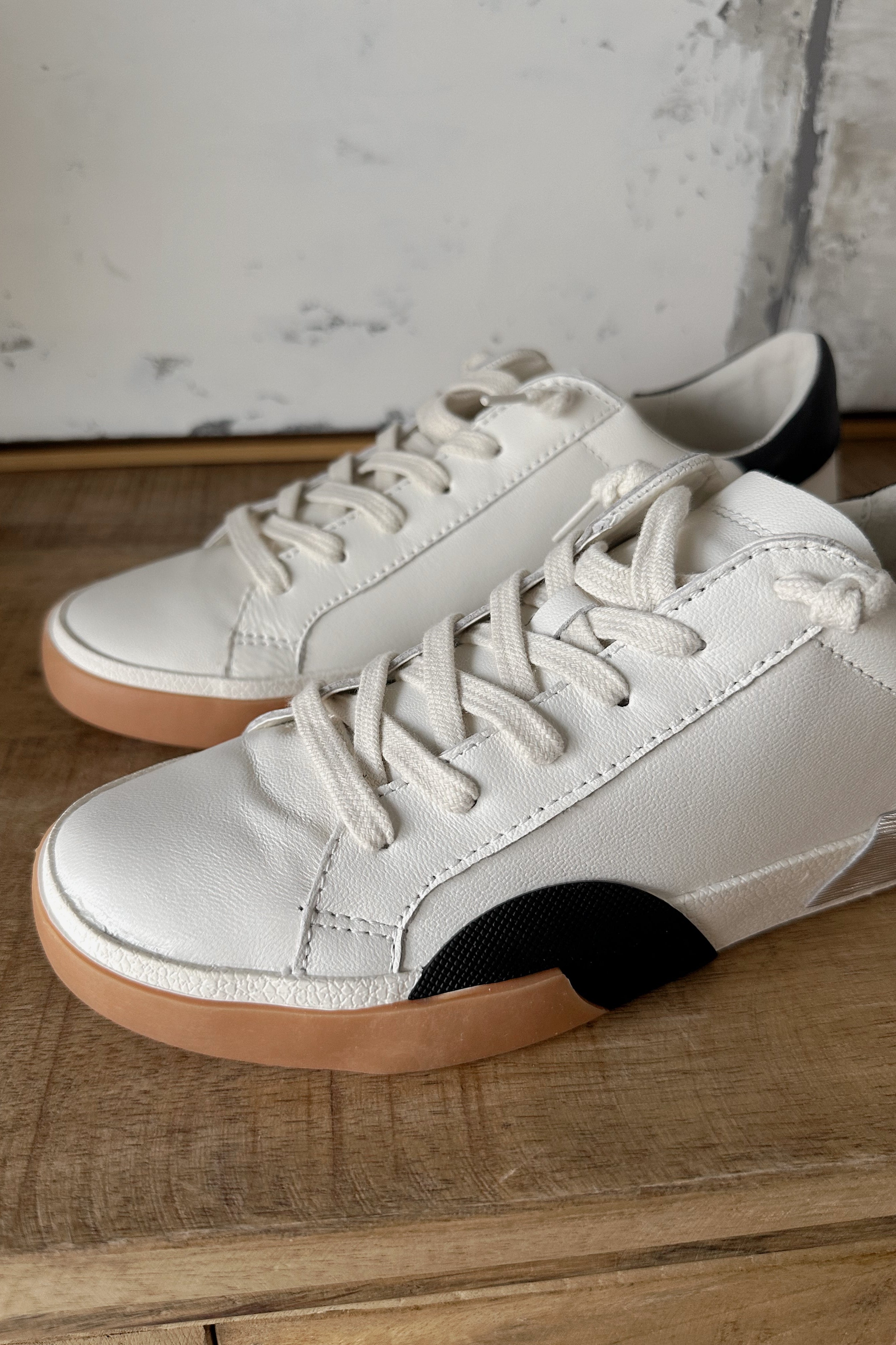 Dolce Vita Zina Sneaker in White Black Leather- close up side view