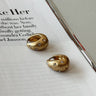 Margaret Gold Starburst Scoop Huggie Earrings - flat lay 