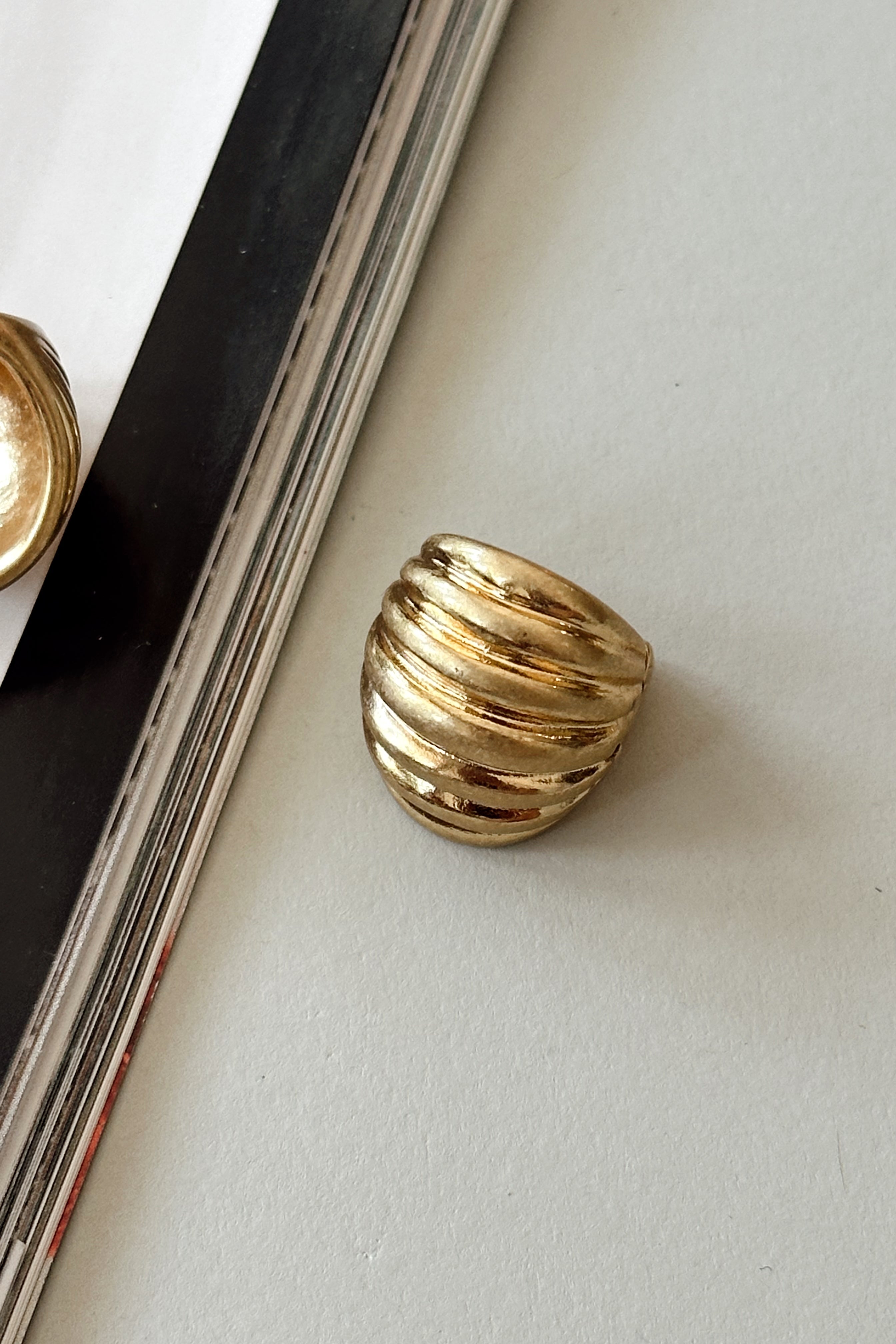 Morgana Gold Ribbed Hoop Earrings - close up flat lay